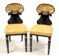 Lot 1314 - A pair of late Regency parcel gilt hall chairs,...