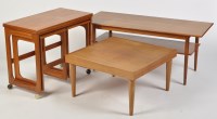 Lot 1151 - A nest of teak coffee tables, the swivel...