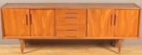 Lot 1182 - A 1970's teak sideboard, fitted five central...