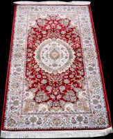 Lot 879 - A woven silk rug, with central circular floral...