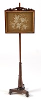 Lot 1004 - A late Regency rosewood pole screen, with...