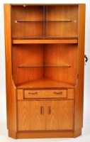 Lot 16 - G-Plan: a teak corner unit, the glazed front...