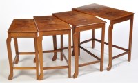 Lot 28 - A nest of four mid 20th Century walnut...