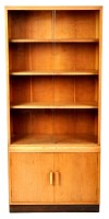 Lot 69 - A mid 20th Century oak wall unit, the glazed...