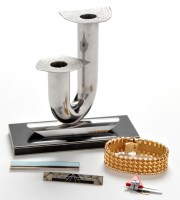 Lot 172 - A bent tubular chrome candlestick with two...