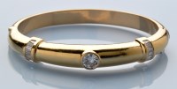 Lot 832 - A diamond and 18ct. yellow gold bangle, the...
