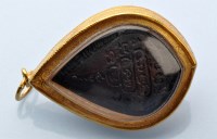Lot 918 - A Buddhist pendant, the cast metal central...