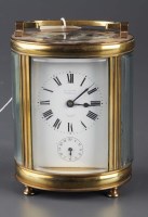 Lot 1280 - A French brass oval carriage timepiece, with...