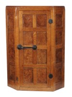 Lot 1424 - A Mouseman oak hanging corner cupboard, with...