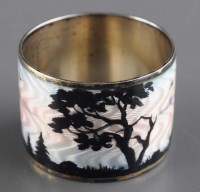 Lot 730 - A Scandinavian enamelled white metal napkin...