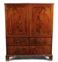 Lot 1081 - A Georgian mahogany small size linen press,...