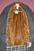 Lot 459 - A Barbour Gamefair green waxed cotton...