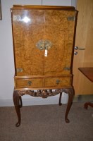 Lot 1848 - A mid 20th Century burr walnut drinks cabinet,...