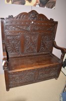 Lot 1862 - An early 20th Century carved oak hall settle,...