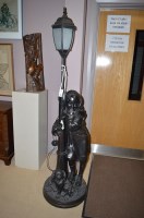 Lot 1865 - A patinated resin standard lamp in the form of...