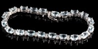 Lot 1007 - An aquamarine and diamond bracelet, the twenty...