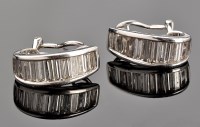 Lot 384 - A pair of diamond earrings, each set with...
