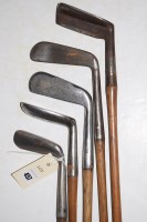 Lot 457 - Five hickory shafted putters, makers to...
