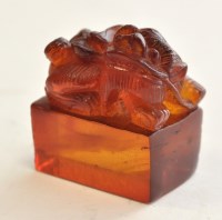 Lot 56 - Chinese amber type figure of a Buddhist lion,...