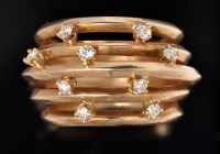 Lot 564 - A diamond and yellow metal ring, the graduated...