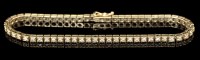 Lot 593 - A diamond tennis bracelet, each of the...