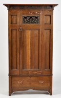 Lot 741 - An Arts & Crafts oak wardrobe, the plain...