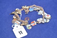 Lot 11 - A yellow metal curb link charm bracelet,...