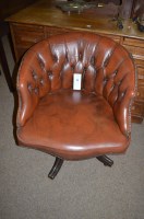Lot 704 - A buttoned back and studded leather swivel...