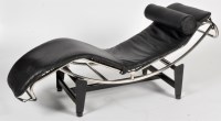 Lot 1009 - A reproduction day bed, in black leatherette...