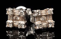 Lot 699 - A pair of diamond earrings, set with brilliant...