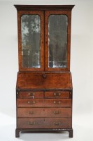 Lot 330 - A George I walnut bureau cabinet, the top with...