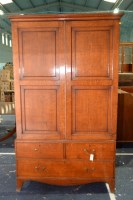 Lot 334 - A George III oak press cupboard, the cavetto...