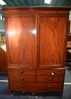 Lot 335 - A George III mahogany linen press, the cavetto...