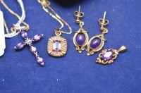 Lot 651 - An amethyst and diamond crucifix pendant on...
