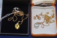 Lot 654 - A 'lemon' citrine and white topaz pendant on...