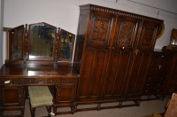 Lot 1229 - A reproduction oak bedroom suite, comprising:...