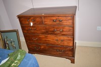 Lot 1273 - A George III mahogany chest of two short and...