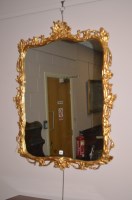 Lot 1274 - A giltwood and gesso framed wall mirror, with...