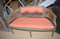 Lot 1283 - A painted beechwood and canework canapé, with...