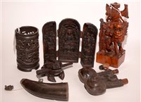 Lot 264 - A carved and varnished wood deity; a carved...