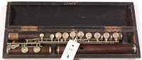 Lot 4 - A.H. Langois rosewood flute with German silver...