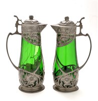 Lot 461 - A pair of WMF style claret jugs, the green...