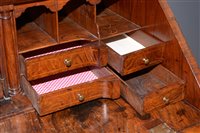 Lot 948 - A George I burr walnut and banded bureau.