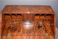 Lot 948 - A George I burr walnut and banded bureau.