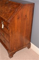 Lot 948 - A George I burr walnut and banded bureau.