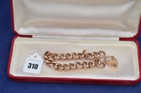 Lot 310 - A yellow metal curb link bracelet.