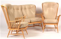 Lot 1097 - Ercol: a light beech Windsor style three-piece suite.