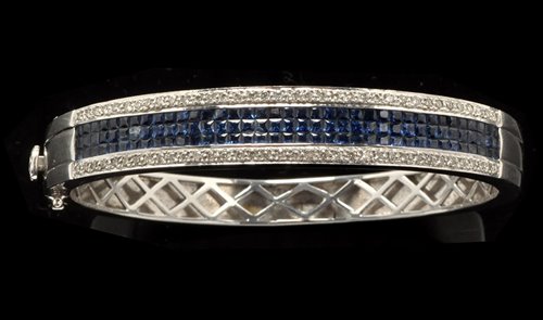 Lot 787 - A sapphire and diamond bangle