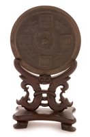 Lot 24 - Chinese bronze mirror disc