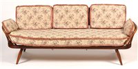 Lot 1089 - Ercol: a stained beech and elm studio couch.